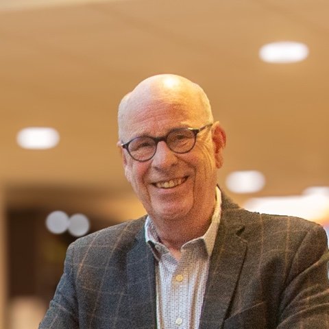 Portret van een lachende vrijwilliger met bril